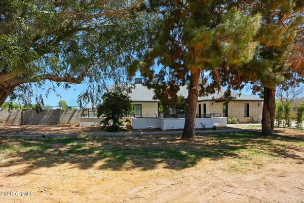 a bedroom with furniture and a wooden floor