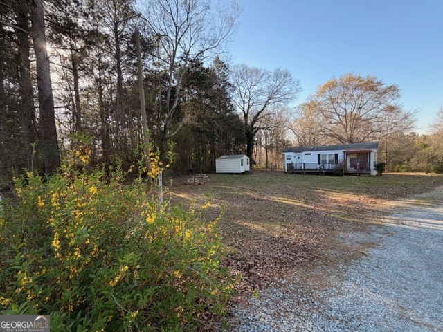 2693 Dempsey Brown Road Dewy Rose, GA 30634 - Photo 15 of 28 a view of a house with a yard covered with snow