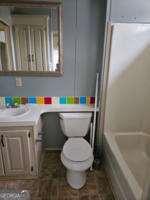2693 Dempsey Brown Road Dewy Rose, GA 30634 - Photo 17 of 28 a bathroom with a sink a toilet and bathtub