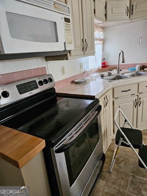 2693 Dempsey Brown Road Dewy Rose, GA 30634 - Photo 23 of 28 a kitchen with a stove microwave and sink