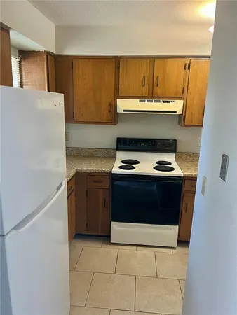 a kitchen with a stove and a refrigerator