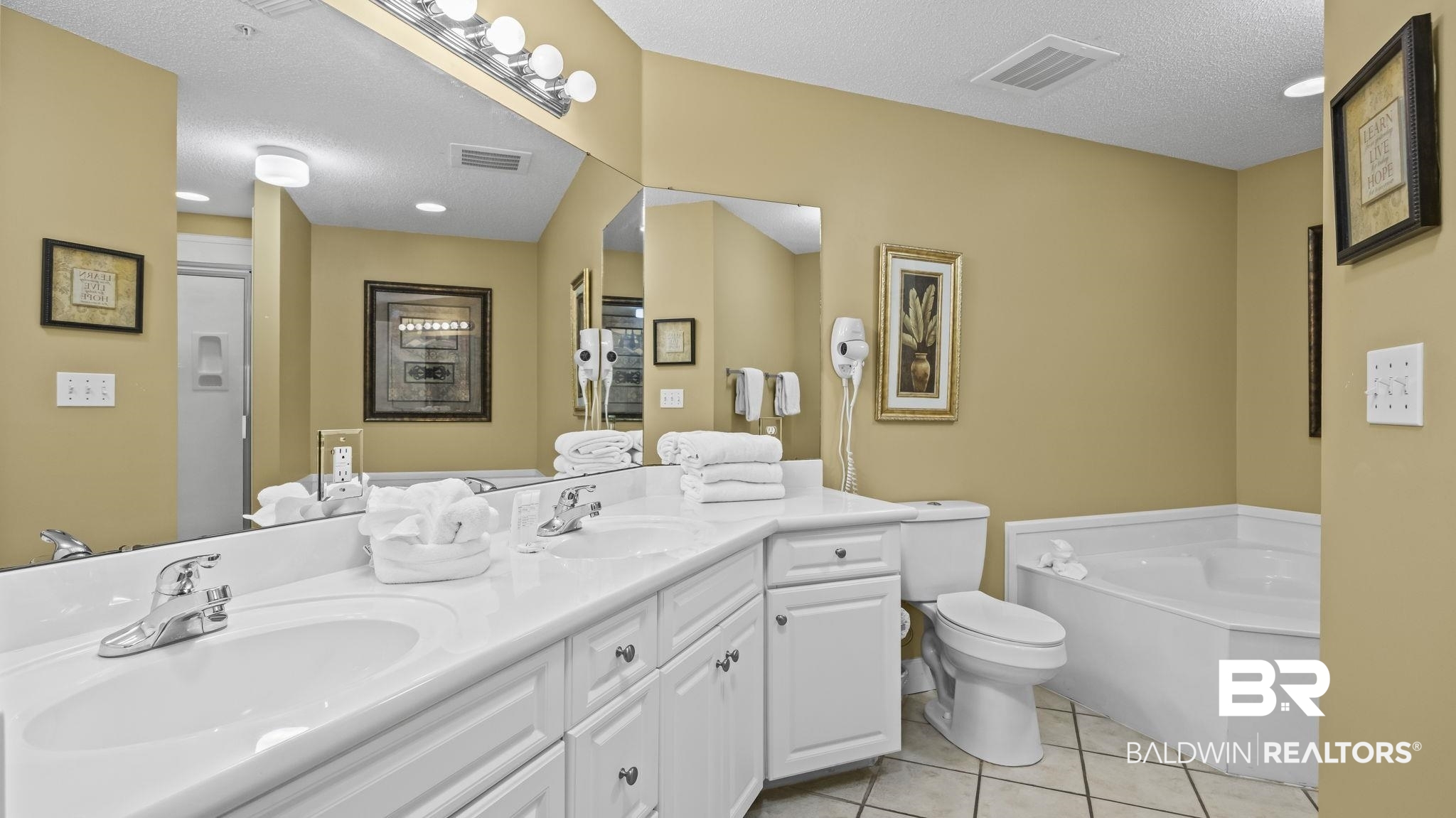 27580 Canal Road, Unit 214 BS 62 Orange Beach, AL 36561 - Photo 9 of 23 Full bathroom with double vanity, a bath, a textured ceiling, light tile patterned floors, and a shower stall