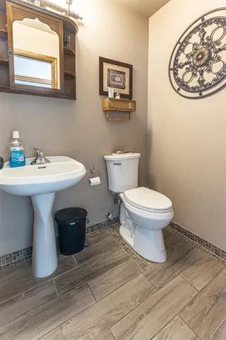 a bathroom with a sink toilet and a mirror