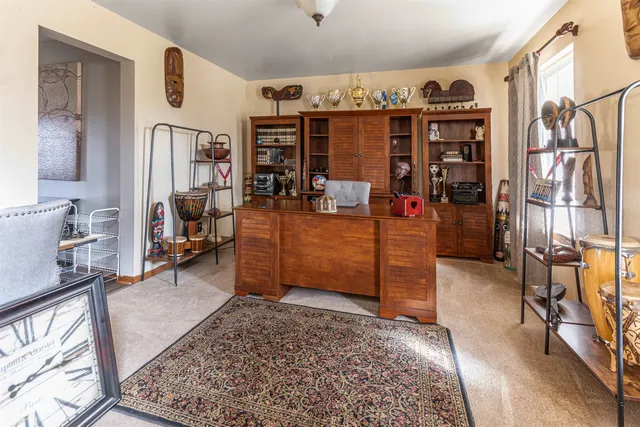 a view of a bedroom with workspace and bedroom