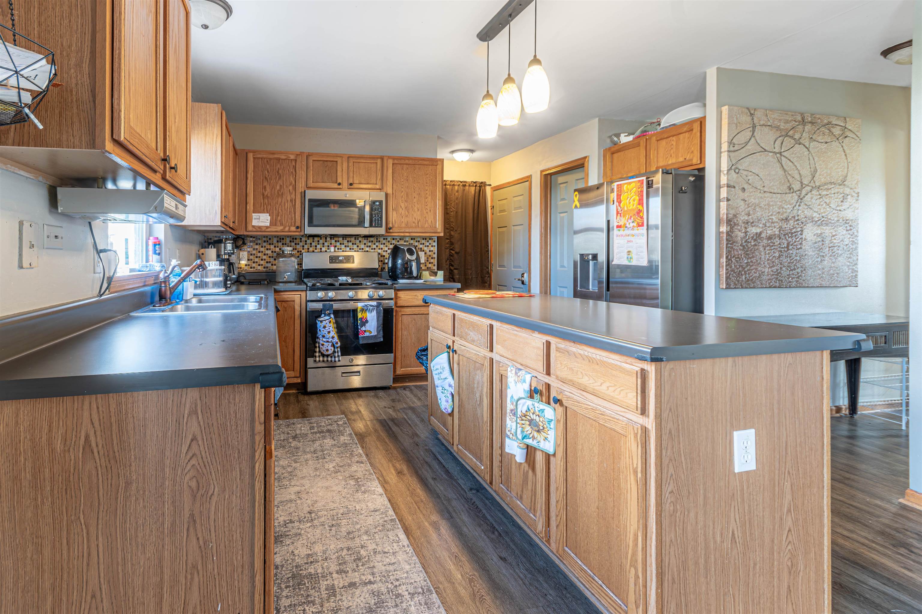 738 Trent Lane Loves Park, IL 61111 - Photo 2 of 37 a kitchen with stainless steel appliances granite countertop a stove and refrigerator