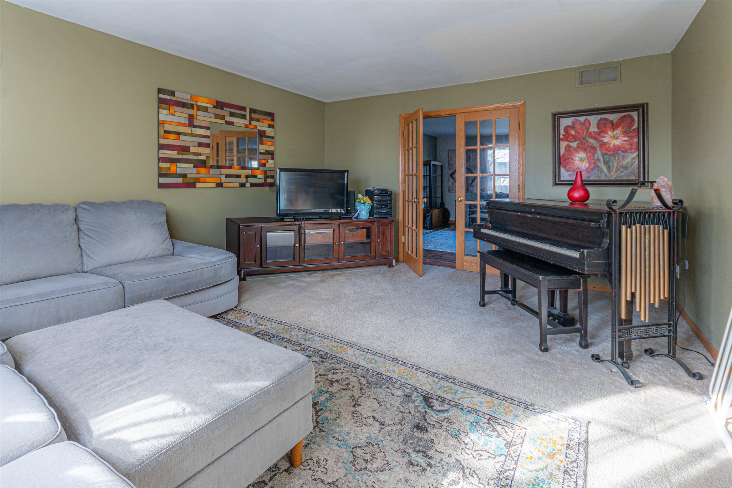 738 Trent Lane Loves Park, IL 61111 - Photo 27 of 37 a living room with furniture and a flat screen tv
