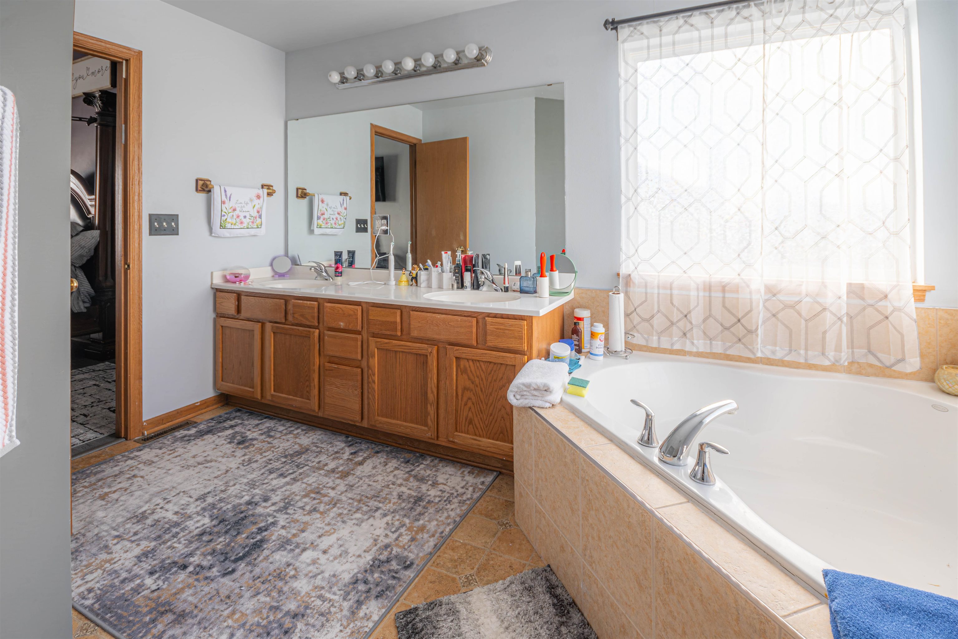 738 Trent Lane Loves Park, IL 61111 - Photo 30 of 37 a bathroom with a tub sink and mirror