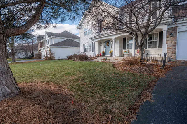 a front view of a house with yard and green space