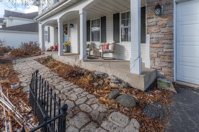 a front view of a house with outdoor seating