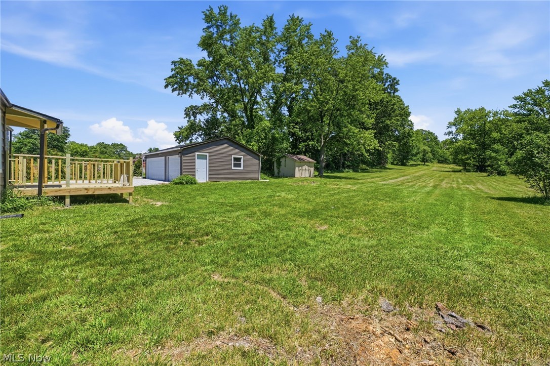 951 Bey Road Akron, OH 44312 - Photo 33 of 34 Expansive green lawn with mature trees and a detached three-car garage and shed