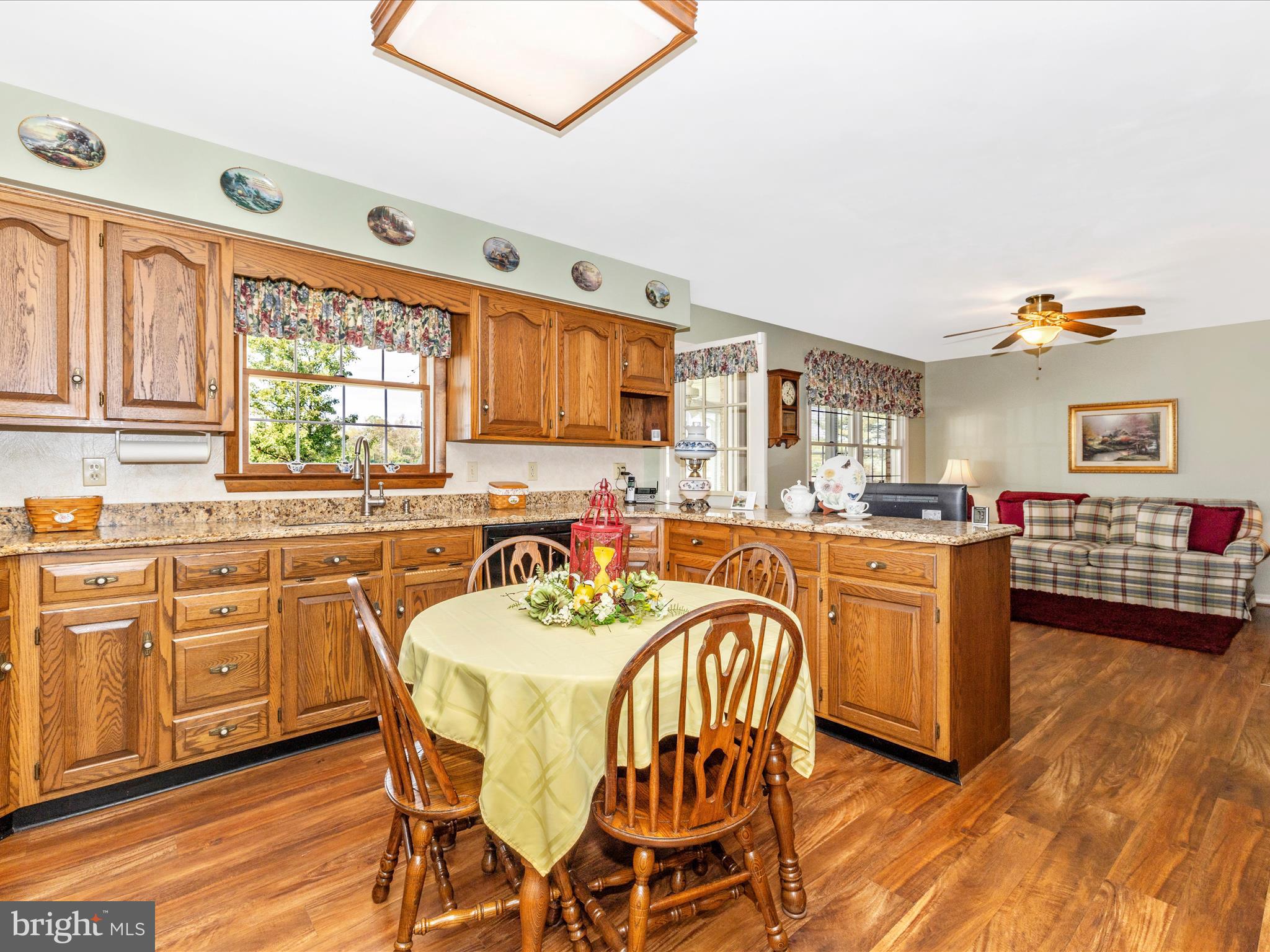 12720 Spickler Road Clear Spring, MD 21722 - Photo 11 of 57 a kitchen with stainless steel appliances granite countertop a stove a sink dishwasher a dining table and chairs with wooden floor