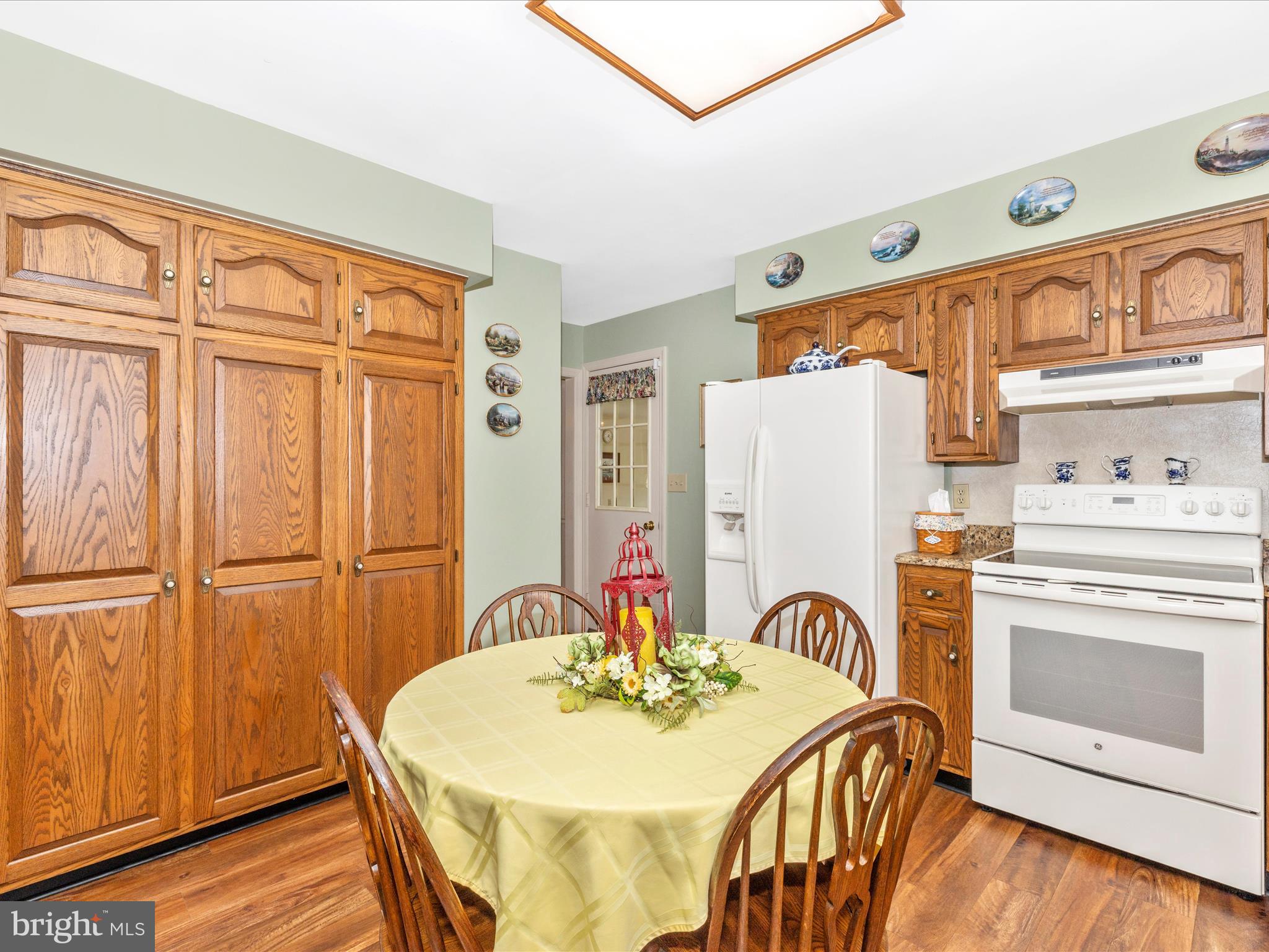 12720 Spickler Road Clear Spring, MD 21722 - Photo 13 of 57 a dining room with furniture a fireplace and wooden floor