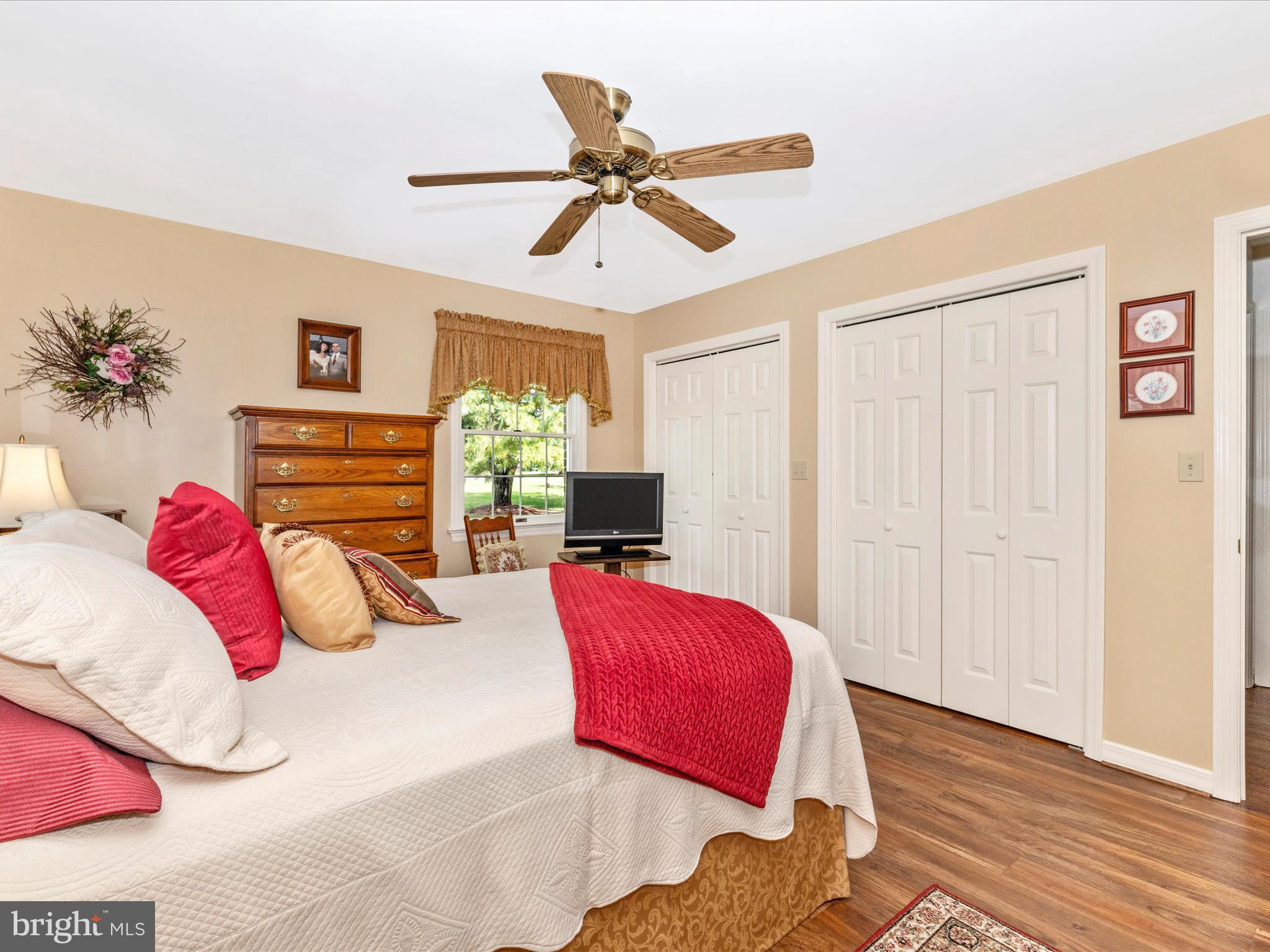 12720 Spickler Road Clear Spring, MD 21722 - Photo 25 of 57 a bedroom with a large bed and a chandelier