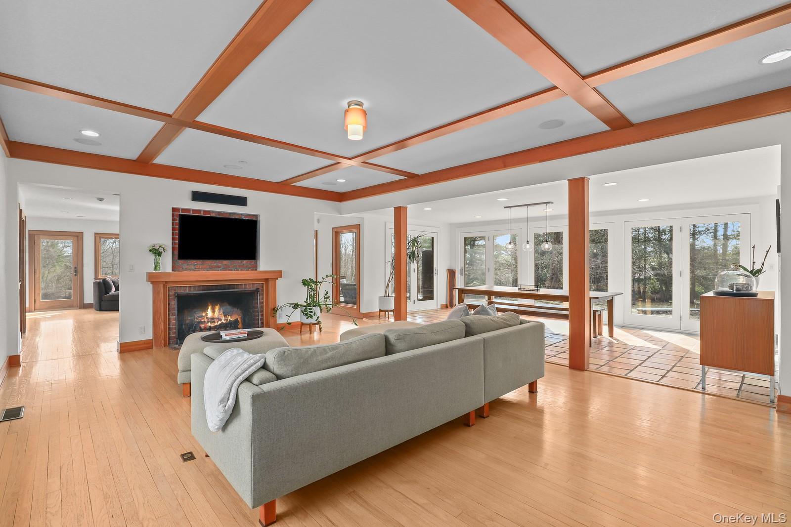37 Hyatt Road Briarcliff Manor, NY 10510 - Photo 5 of 37 Living room with custom coffered ceiling, fireplace, and walls of glass