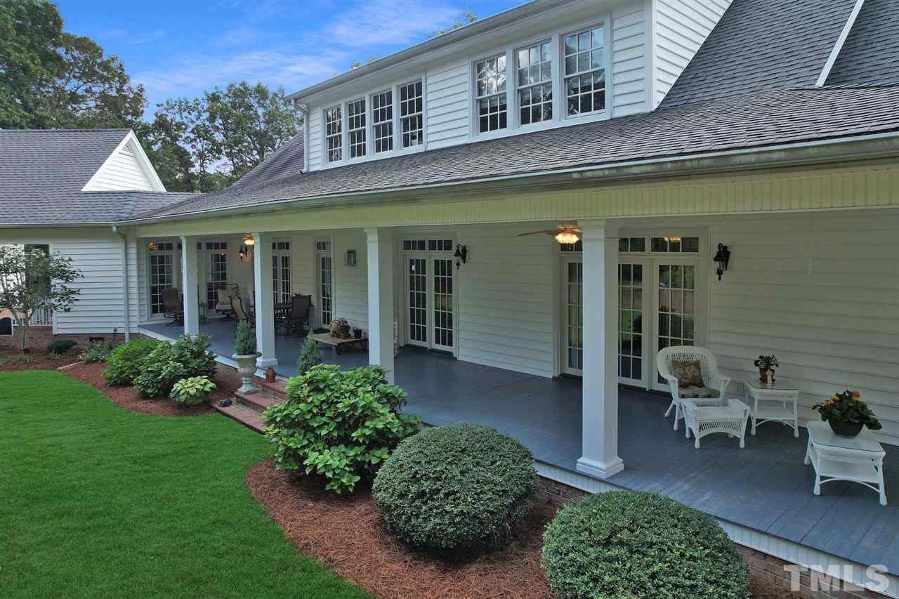 Covered back porch with wood flooring and beaded ceiling is simple amazing.