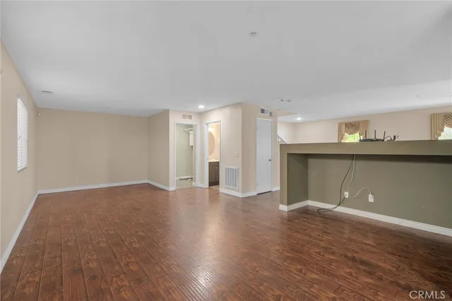 a view of a kitchen with wooden floor and a sink