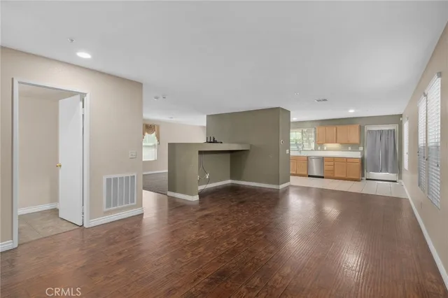 a view of a kitchen with a sink and a refrigerator