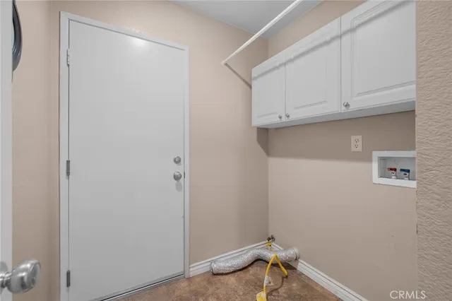 a view of storage and utility room with racks on the wall