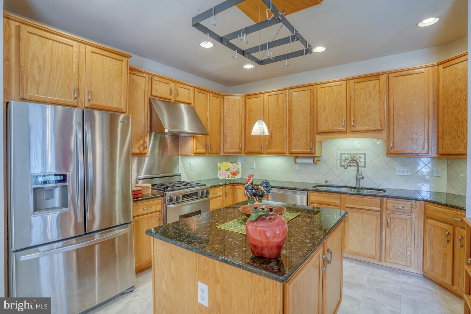 78 Springmill Drive Middletown, DE 19709 - Photo 28 of 60 a kitchen with stainless steel appliances granite countertop a sink refrigerator and cabinets