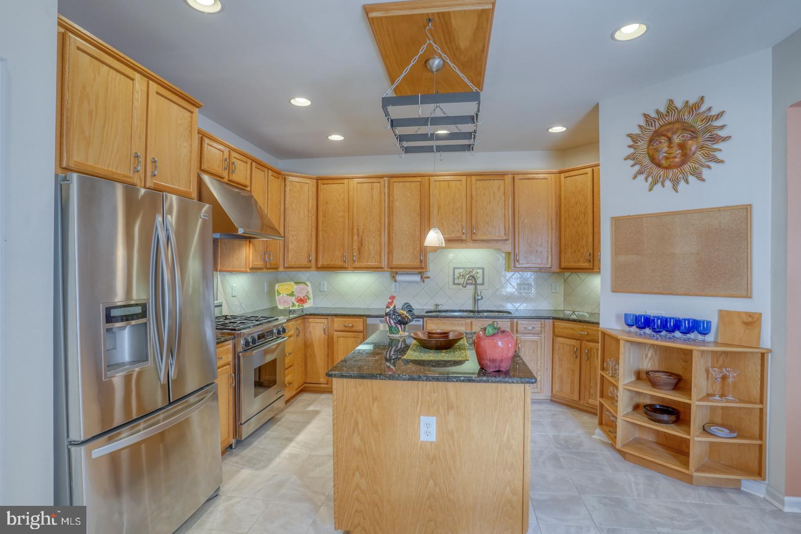 78 Springmill Drive Middletown, DE 19709 - Photo 29 of 60 a kitchen with stainless steel appliances granite countertop a refrigerator and a stove