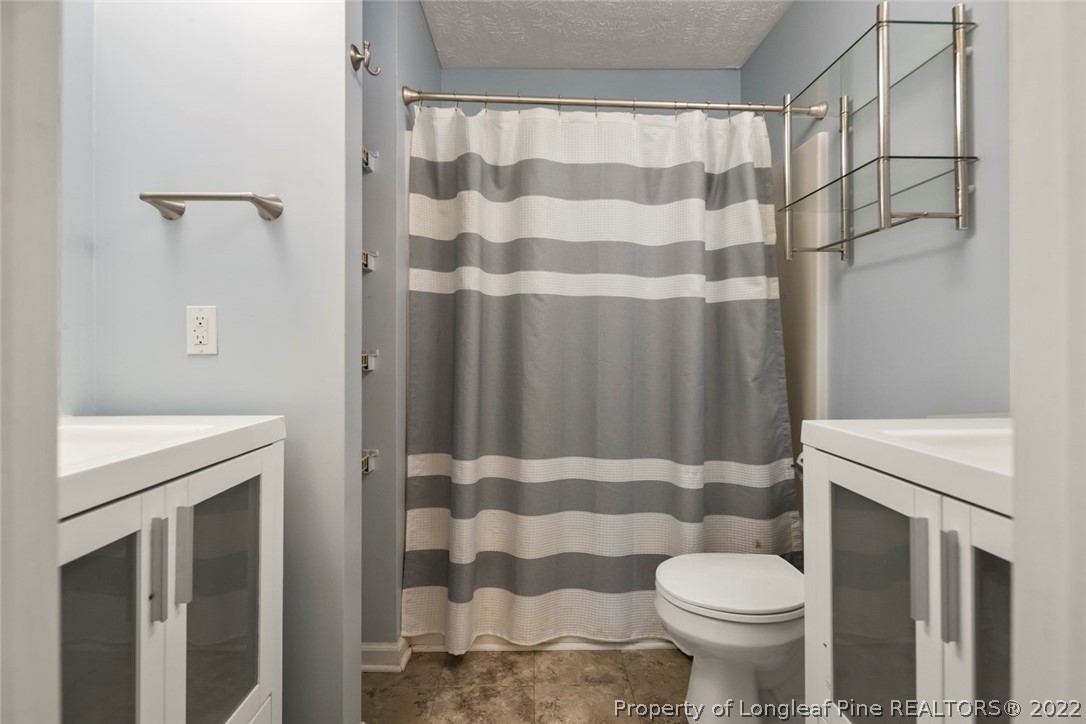 8209 Rockfish Road Raeford, NC 28376 - Photo 11 of 42 a bathroom with a sink toilet and shower