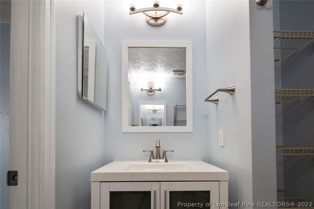 8209 Rockfish Road Raeford, NC 28376 - Photo 13 of 42 a bathroom with a sink and a mirror