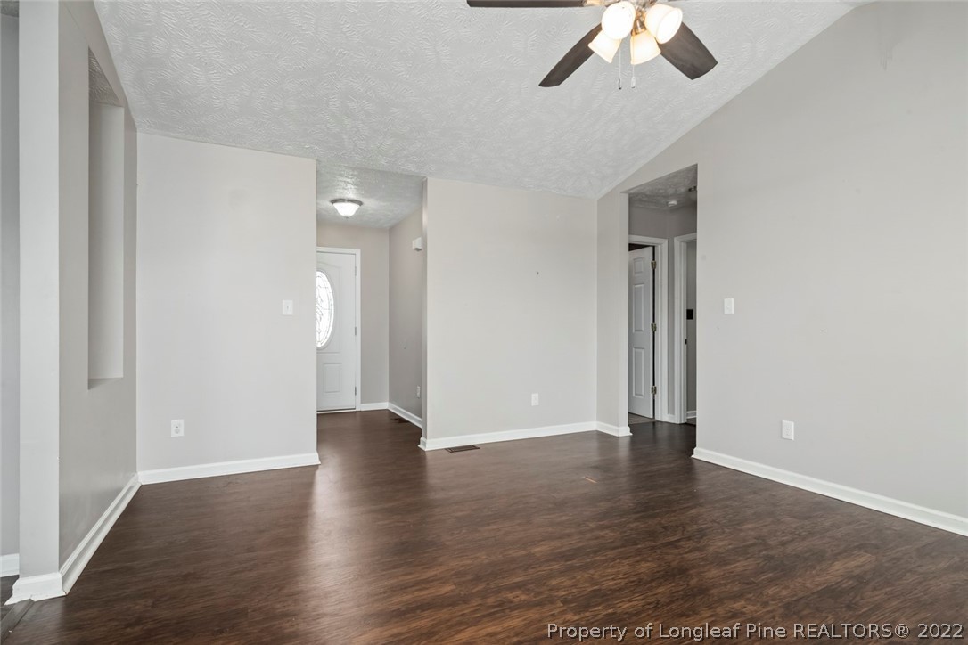8209 Rockfish Road Raeford, NC 28376 - Photo 18 of 42 a view of an empty room with wooden floor