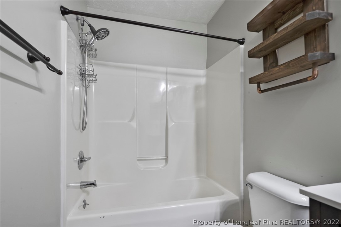 8209 Rockfish Road Raeford, NC 28376 - Photo 21 of 42 a bathroom with a shower and a toilet