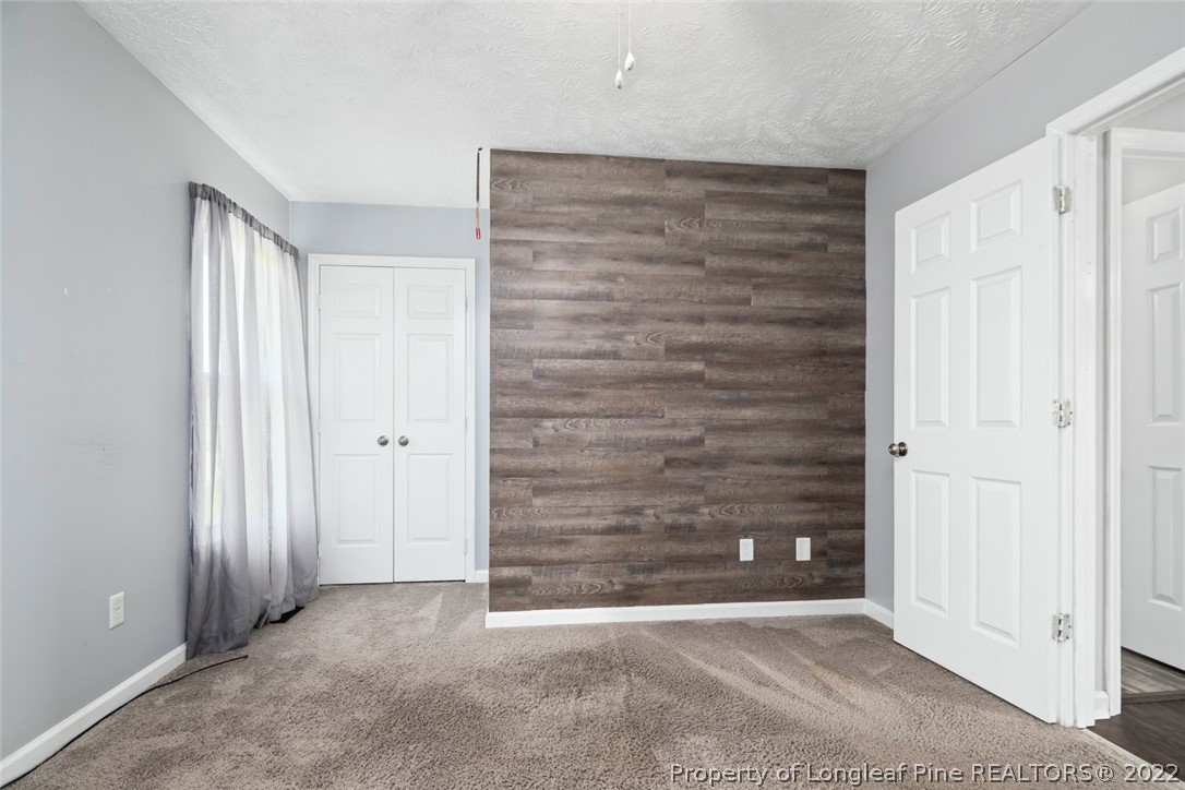 8209 Rockfish Road Raeford, NC 28376 - Photo 23 of 42 a view of an empty room with wooden door