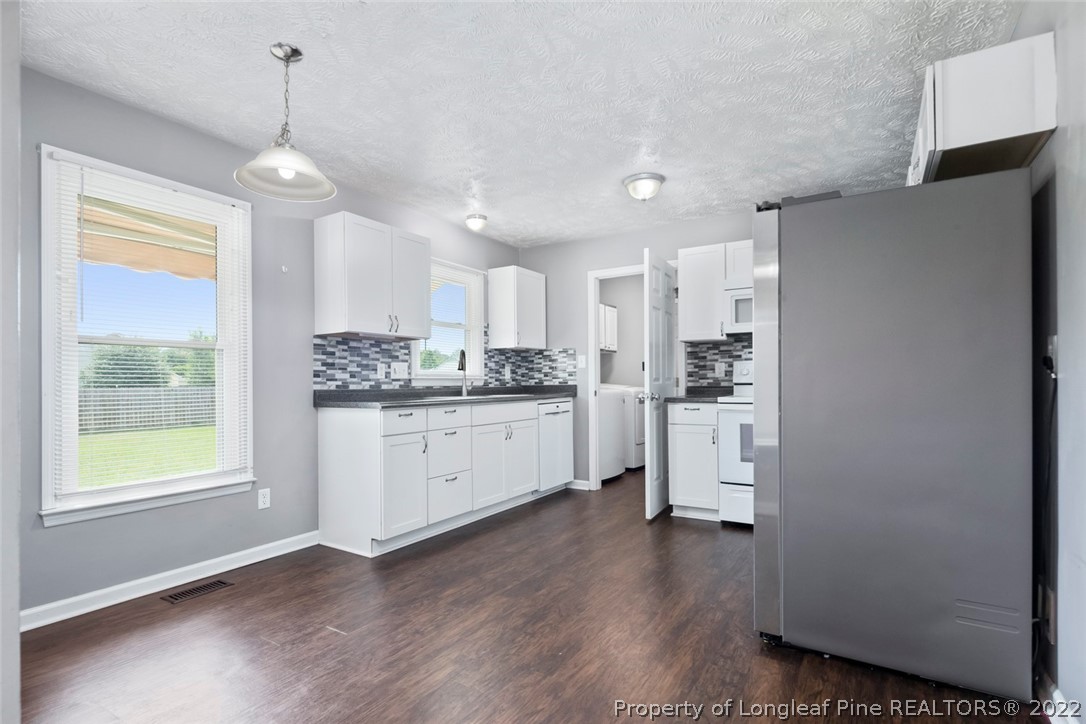 8209 Rockfish Road Raeford, NC 28376 - Photo 26 of 42 a kitchen with stainless steel appliances a refrigerator sink and cabinets