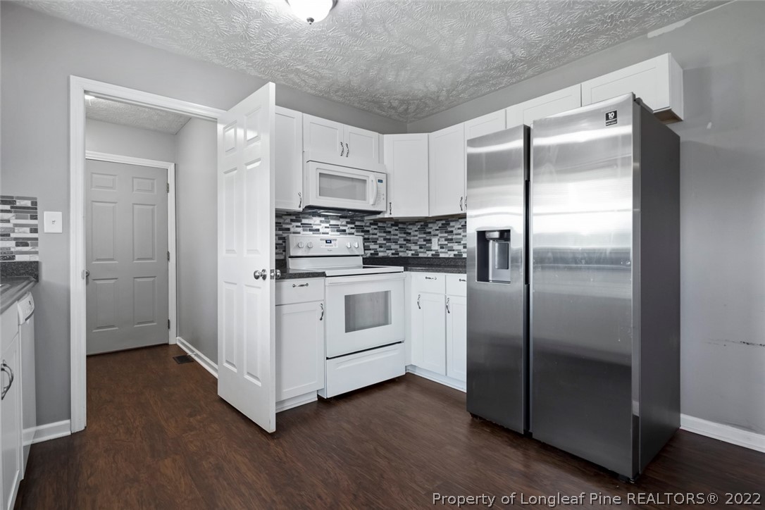 8209 Rockfish Road Raeford, NC 28376 - Photo 27 of 42 a kitchen with stainless steel appliances a refrigerator sink and cabinets