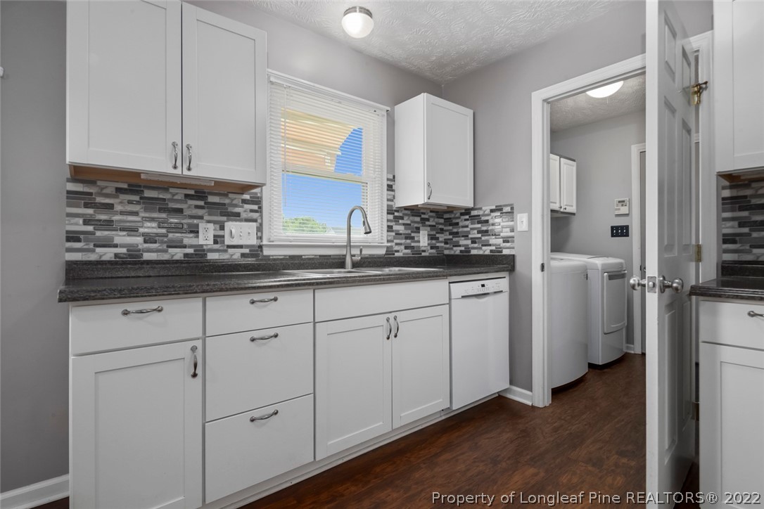 8209 Rockfish Road Raeford, NC 28376 - Photo 29 of 42 a kitchen with white cabinets and sink