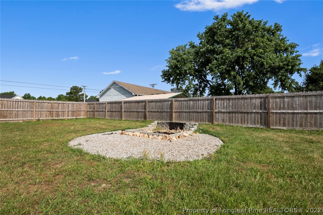 8209 Rockfish Road Raeford, NC 28376 - Photo 36 of 42 a view of a backyard with wooden fence