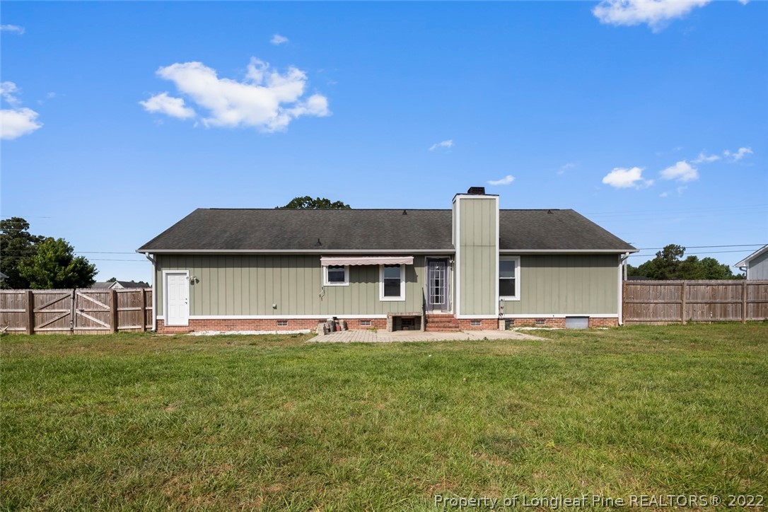 8209 Rockfish Road Raeford, NC 28376 - Photo 41 of 42 a front view of house with yard and trees in the background
