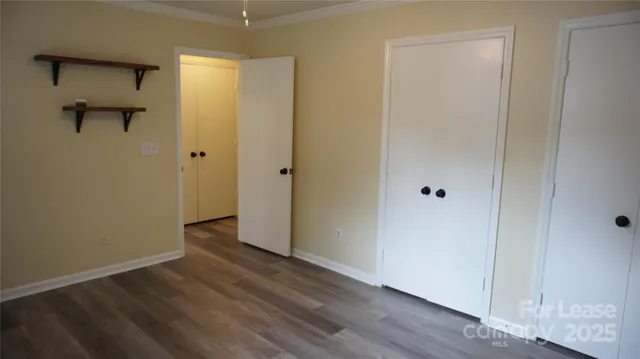 a view of a room with wooden floor