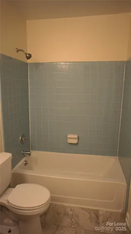 a bathroom with a toilet and a bathtub
