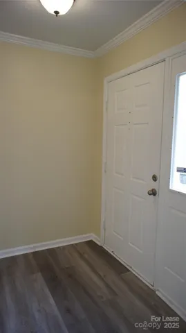 an empty room with wooden floor and window