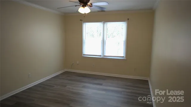 a view of a room with wooden floor and windows