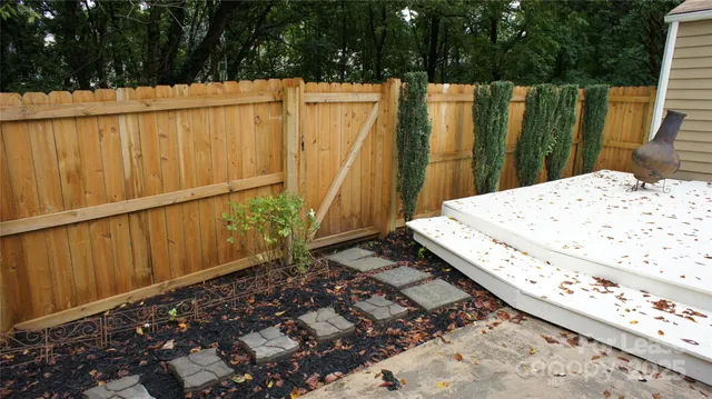a view of a backyard with wooden fence