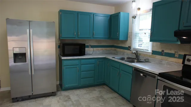 a kitchen with a sink stove and refrigerator