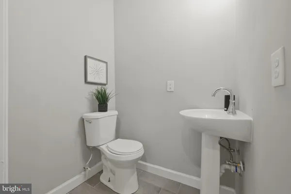 a white toilet sitting next to a bathroom sink