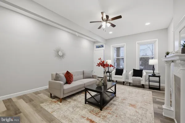 a living room with furniture and flowers