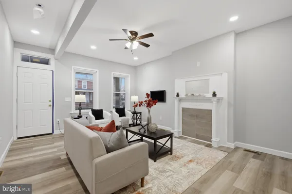 a living room with furniture and kitchen view
