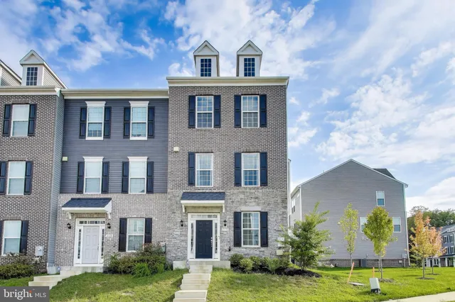 a front view of a residential apartment building with a yard