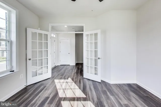 a view of wooden floor and windows in a room