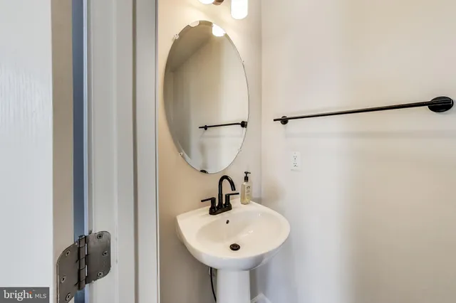 a bathroom with a sink a mirror and shower