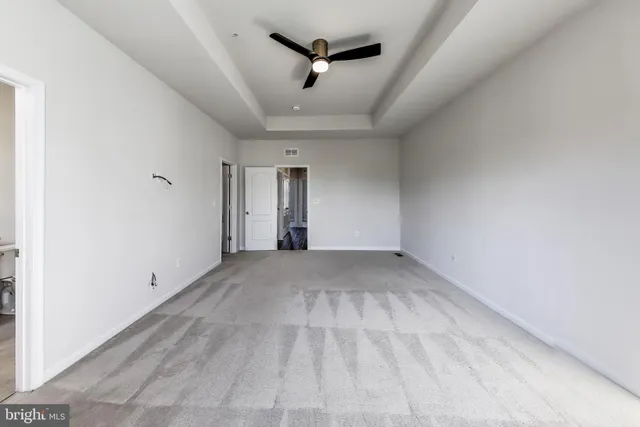 a view of empty room with ceiling fan