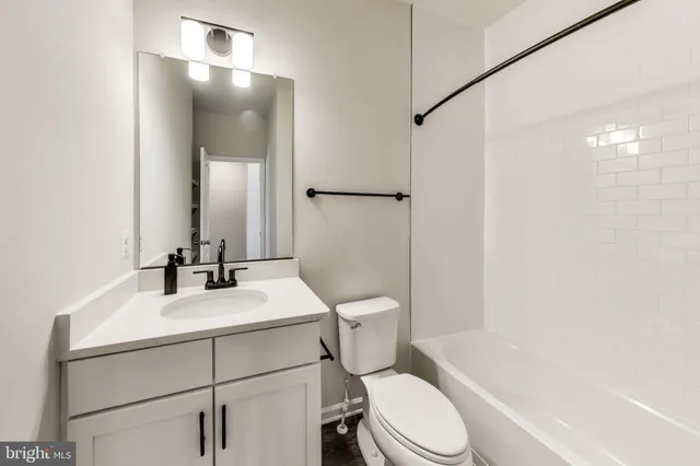 a bathroom with a sink toilet vanity and shower