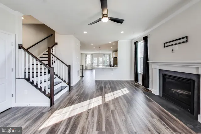 a view of a livingroom with wooden floor and a fireplace