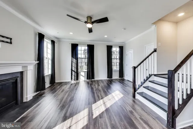 a view of staircase with wooden floor and fireplace